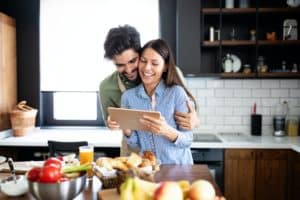 Beautiful couple in the kitchen while cooking